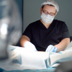 man in surgery performing surgery on patient